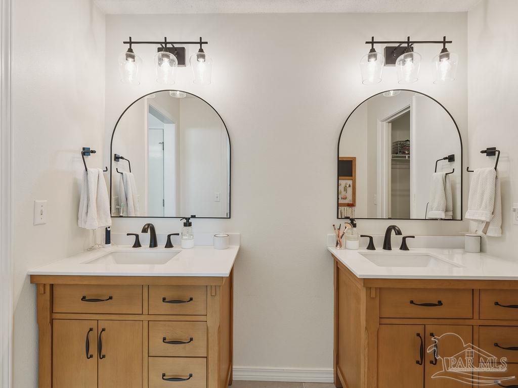 446 Sandy Ridge Circle Mary Esther, FL 32569 - Photo 11 of 26 a bathroom with a sink a mirror and vanity