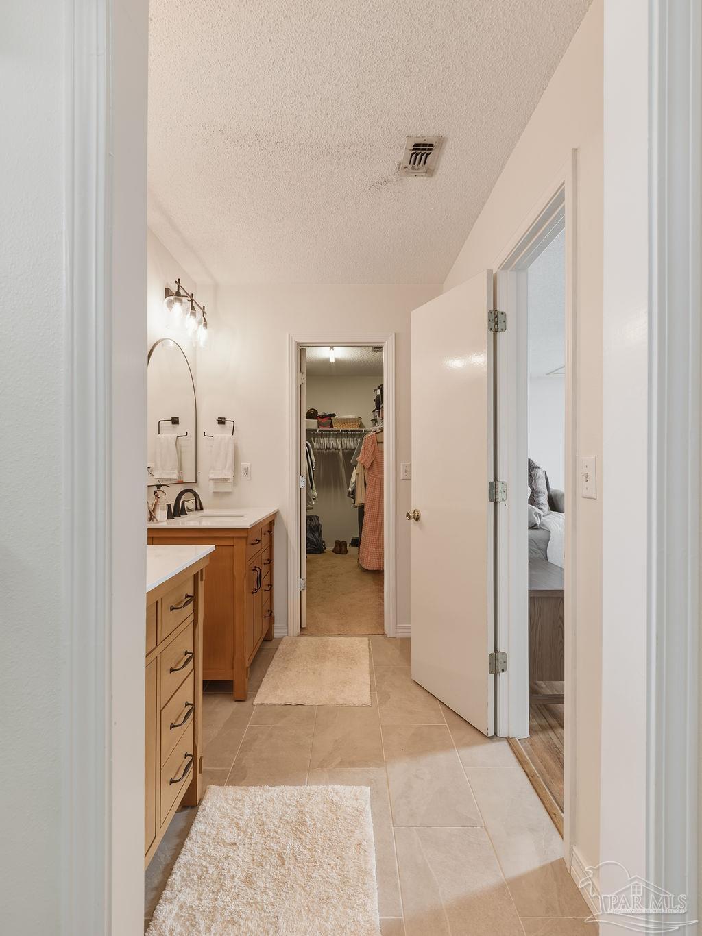 446 Sandy Ridge Circle Mary Esther, FL 32569 - Photo 15 of 26 a large bathroom with a sink and a mirror