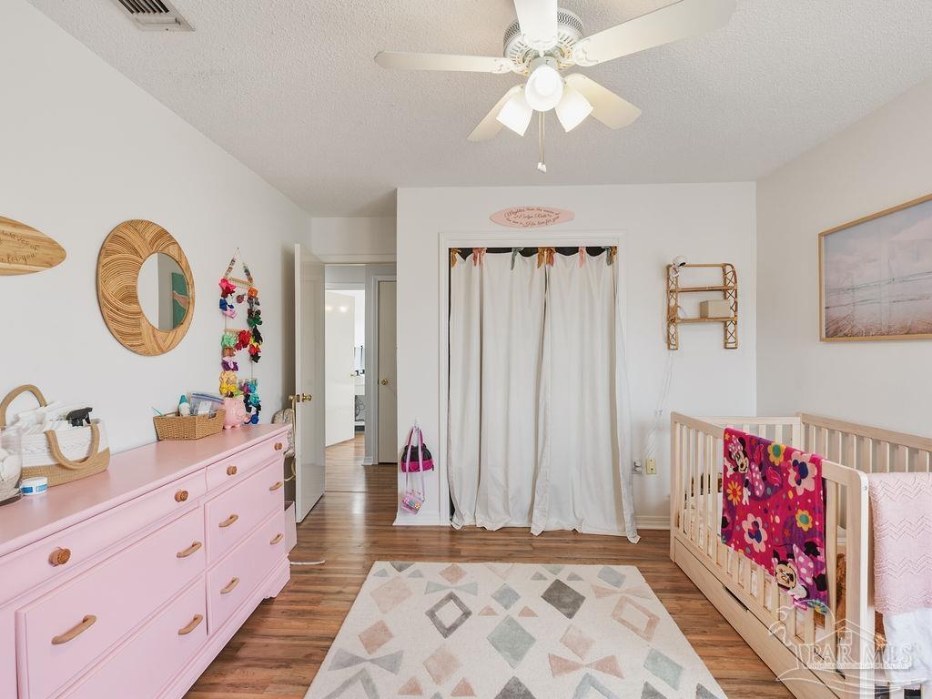 446 Sandy Ridge Circle Mary Esther, FL 32569 - Photo 18 of 26 a very nice looking bedroom with a large bed and a chandelier