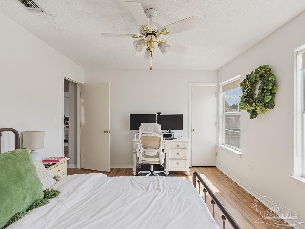 446 Sandy Ridge Circle Mary Esther, FL 32569 - Photo 21 of 26 a bedroom with a bed and a chandelier