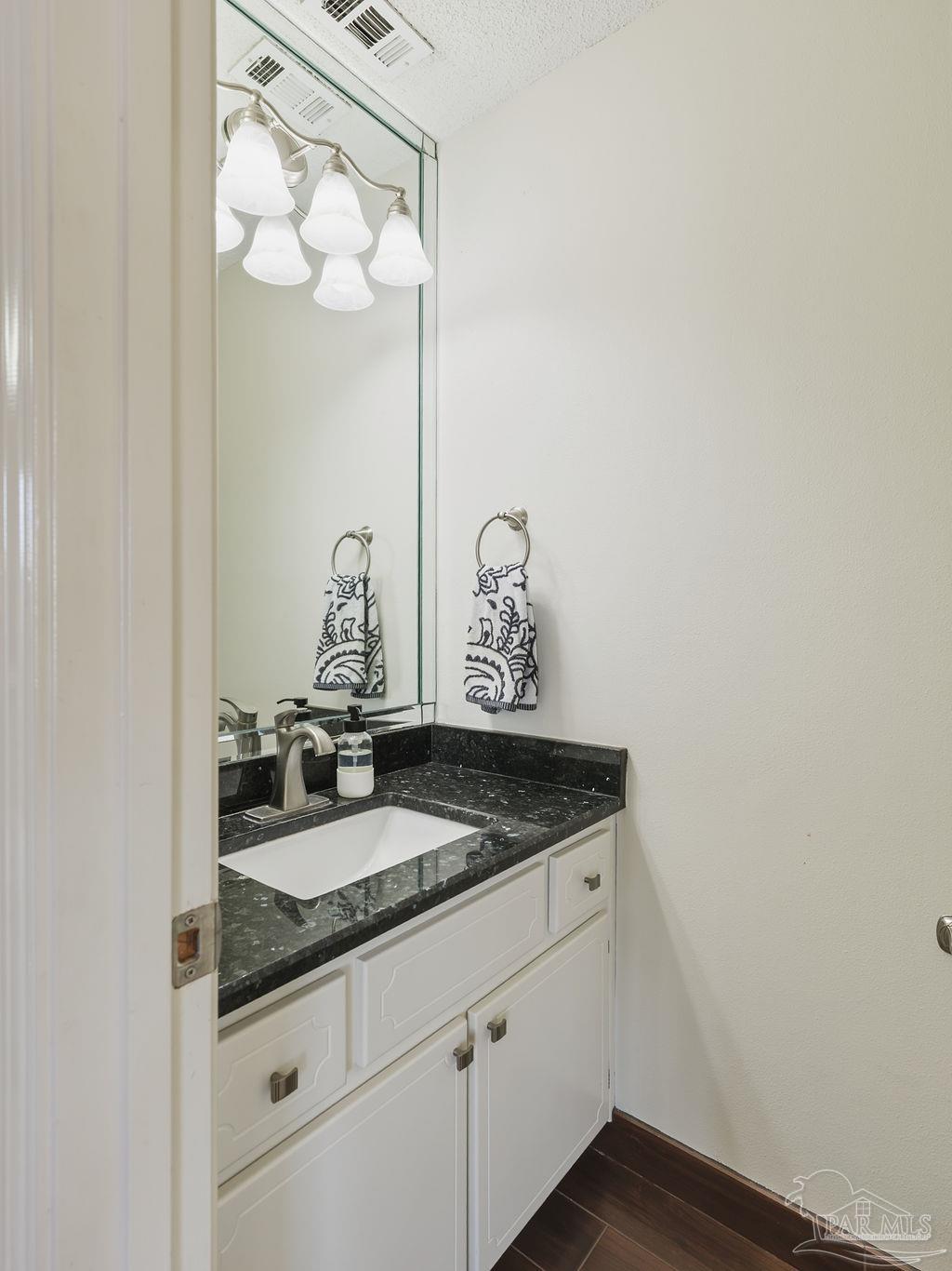446 Sandy Ridge Circle Mary Esther, FL 32569 - Photo 22 of 26 a bathroom with a granite countertop sink and a mirror