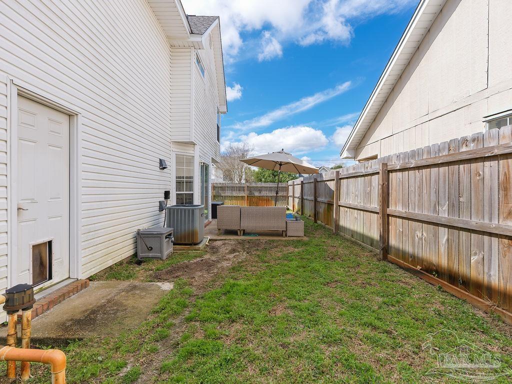 446 Sandy Ridge Circle Mary Esther, FL 32569 - Photo 25 of 26 a view of a chair and table in backyard of the house