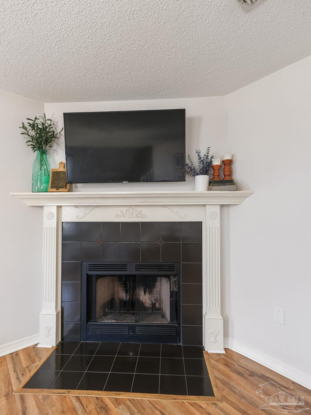 446 Sandy Ridge Circle Mary Esther, FL 32569 - Photo 4 of 26 a living room with a fireplace and a potted plant