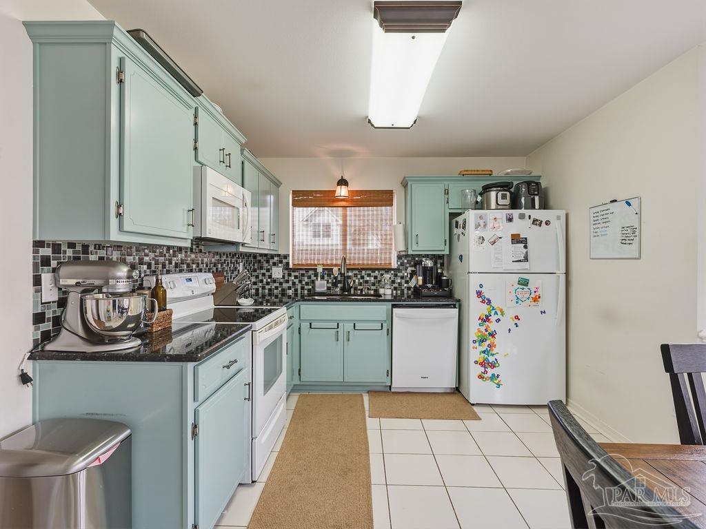 446 Sandy Ridge Circle Mary Esther, FL 32569 - Photo 5 of 26 a kitchen with a refrigerator sink stove and cabinets