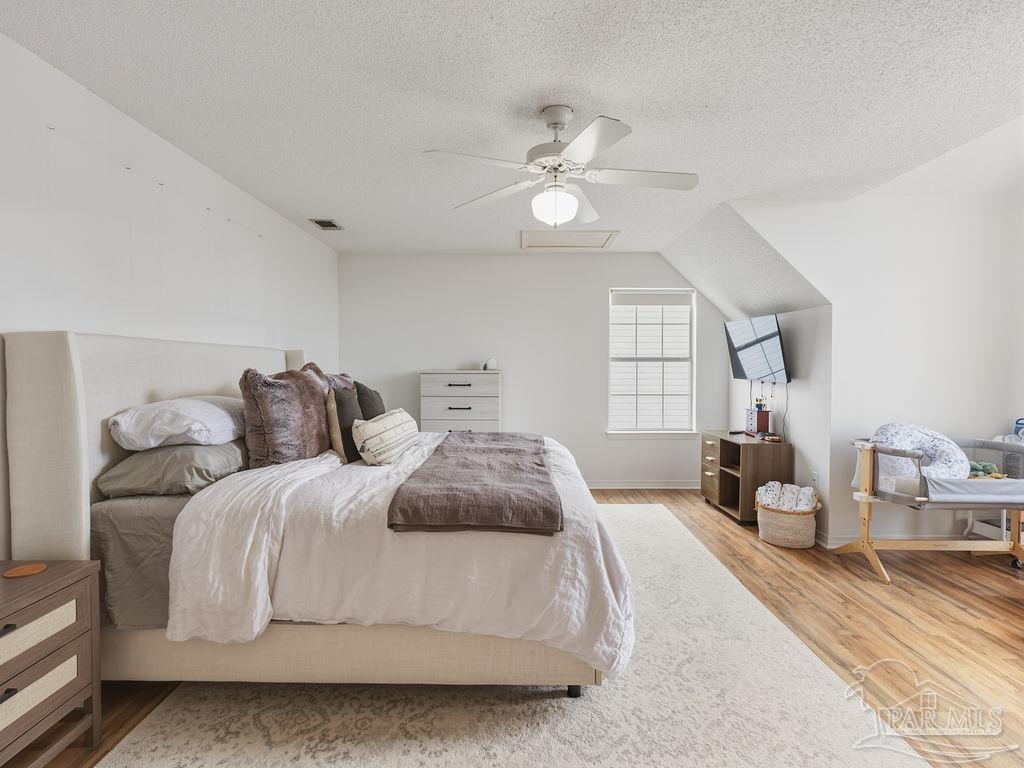 446 Sandy Ridge Circle Mary Esther, FL 32569 - Photo 9 of 26 a spacious bedroom with a large bed and a chandelier