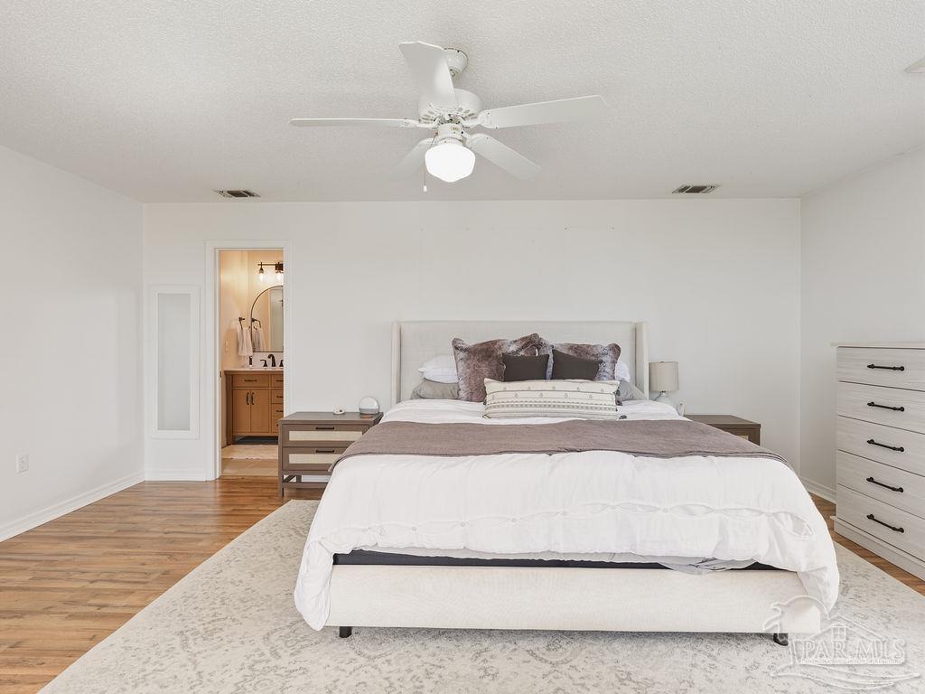 446 Sandy Ridge Circle Mary Esther, FL 32569 - Photo 10 of 26 a bedroom with a bed and a chandelier