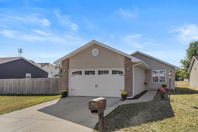 a front view of a house with parking space