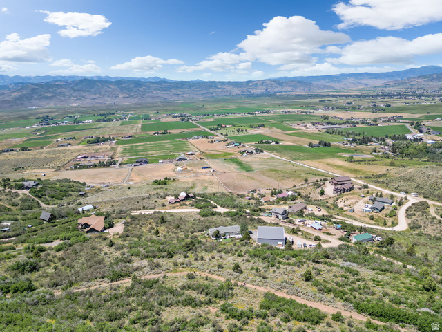 2459 Painter Road Marion, UT 84036 - Photo 28 of 42 Expansive aerial perspective showcasing a mountainous backdrop, agricultural fields, and scattered residential properties