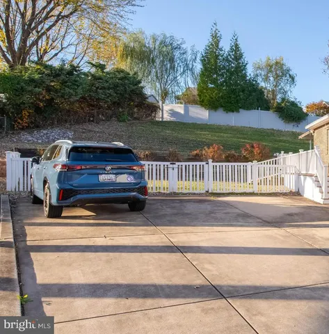 a view of a yard in front of a house with a fountain