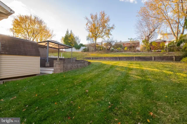a view of a porch with chairs and backyard