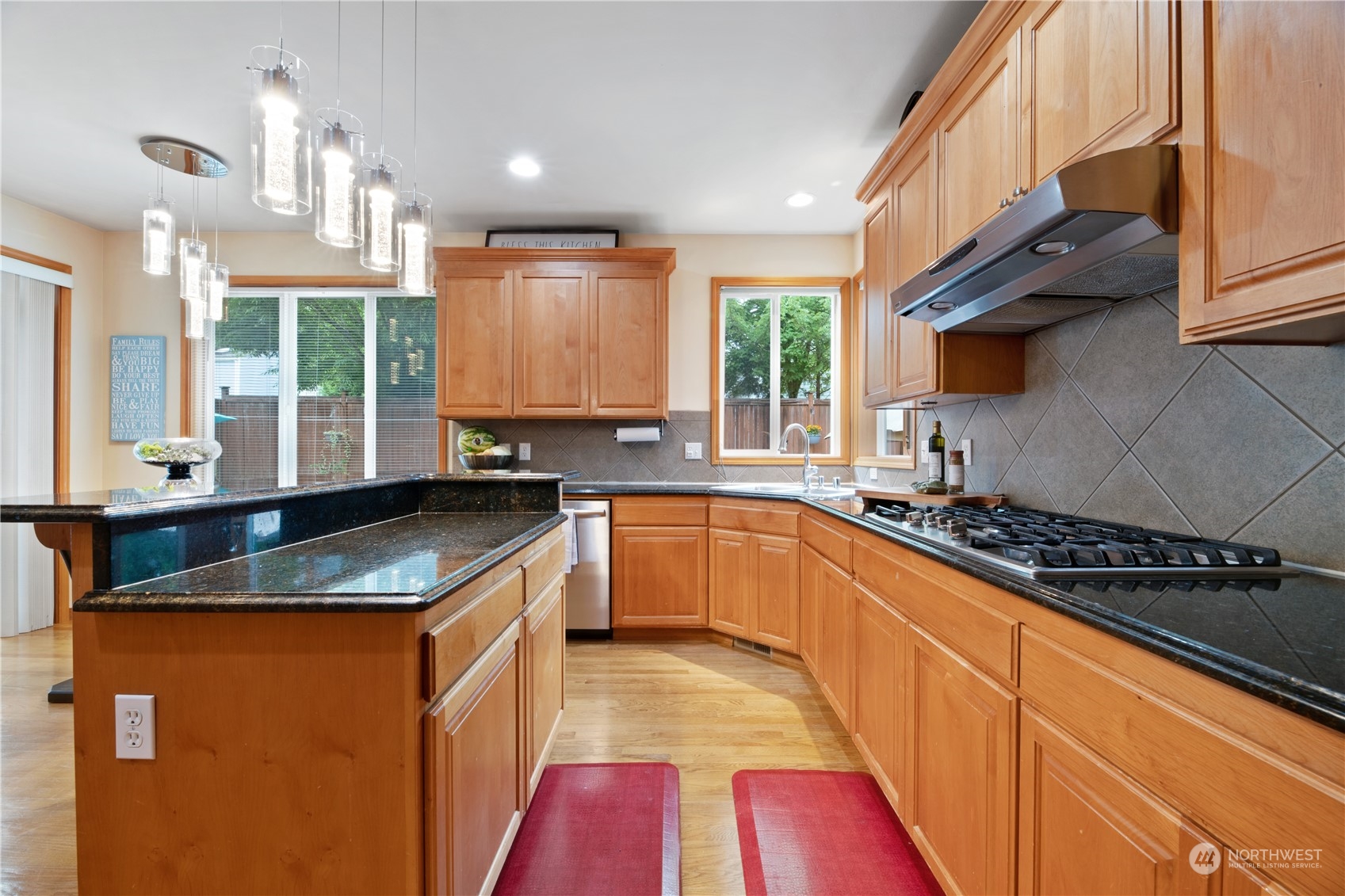 3521 214th Place Southeast Bothell, WA 98021 - Photo 10 of 35 a kitchen with stainless steel appliances granite countertop a sink stove and cabinets