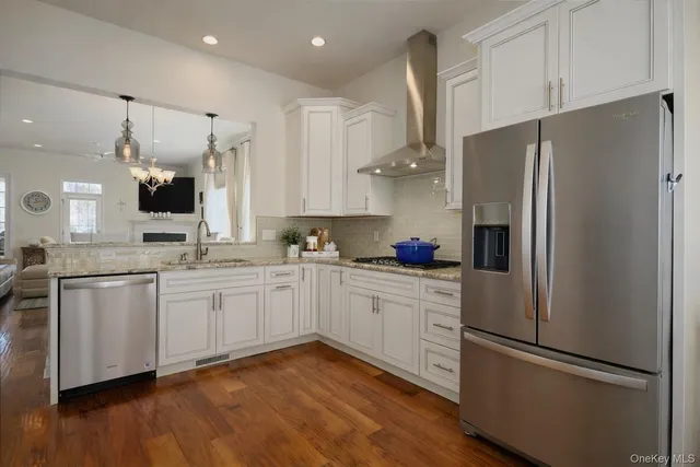 a kitchen with stainless steel appliances a refrigerator sink and cabinets