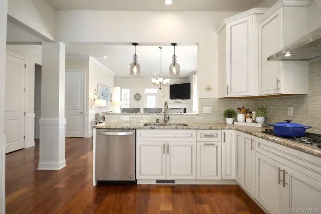 a kitchen with a sink cabinets and wooden floor