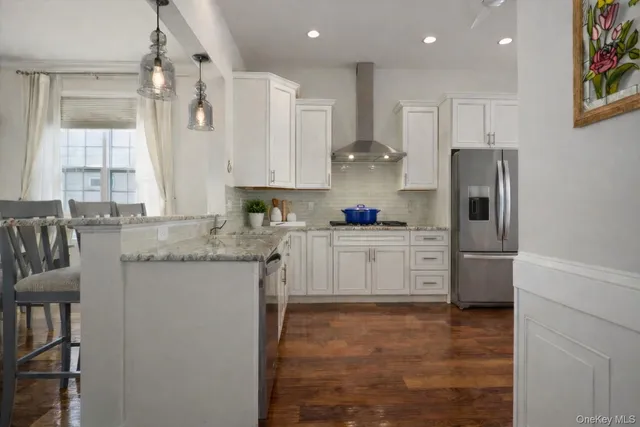 a kitchen with stainless steel appliances granite countertop a refrigerator sink and cabinets