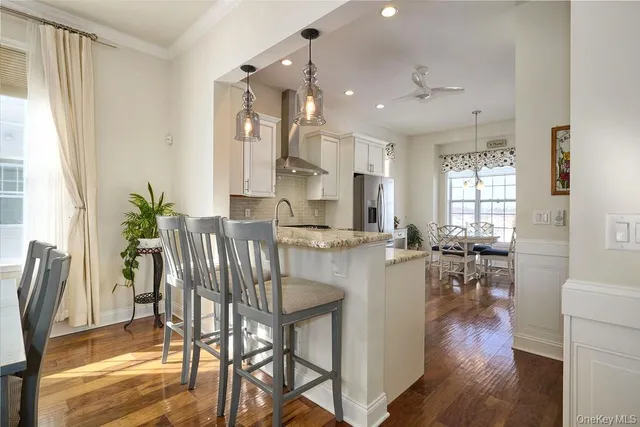 a dining room with furniture and wooden floor