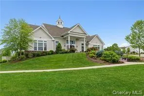 a view of a lake with a house and a yard