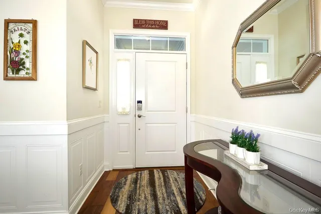 a bedroom with a bed and a mirror on the wall