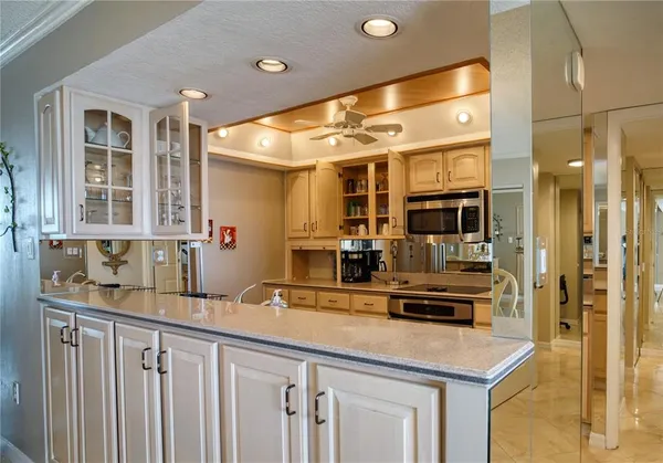 a kitchen with stainless steel appliances a sink and cabinets