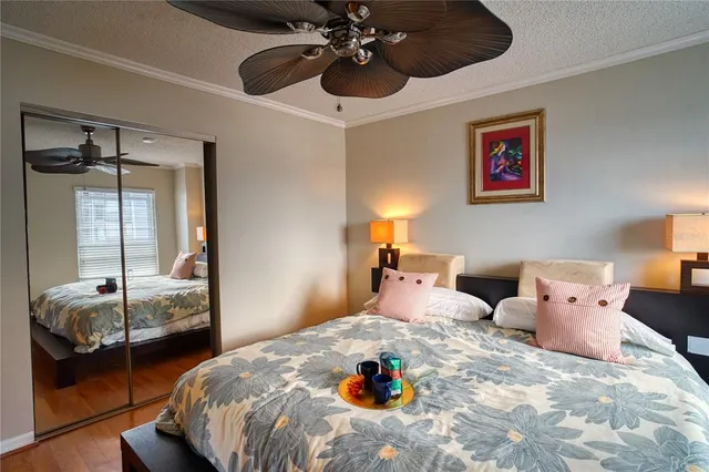 a bedroom with a large bed and wooden floor