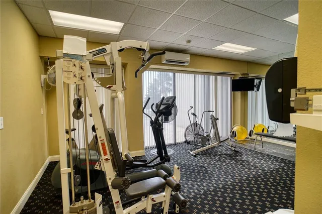 a room with pool table and windows
