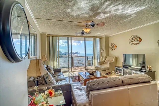 a living room with furniture and a floor to ceiling window