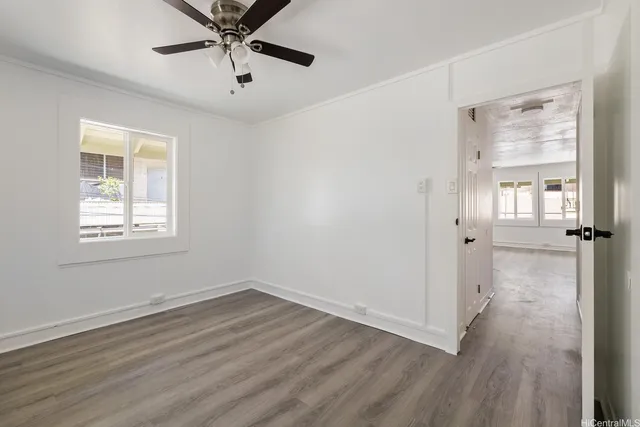 wooden floor in an empty room with a window