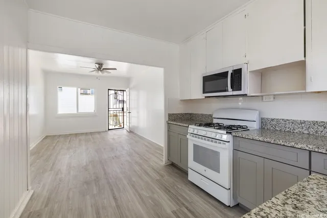 a kitchen with a stove top oven sink and cabinets