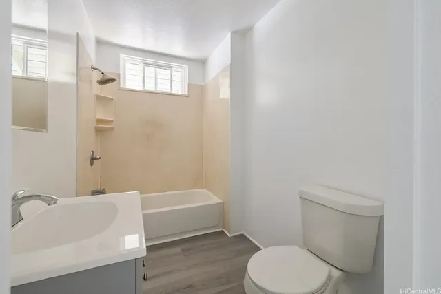 a bathroom with a toilet and a bathtub