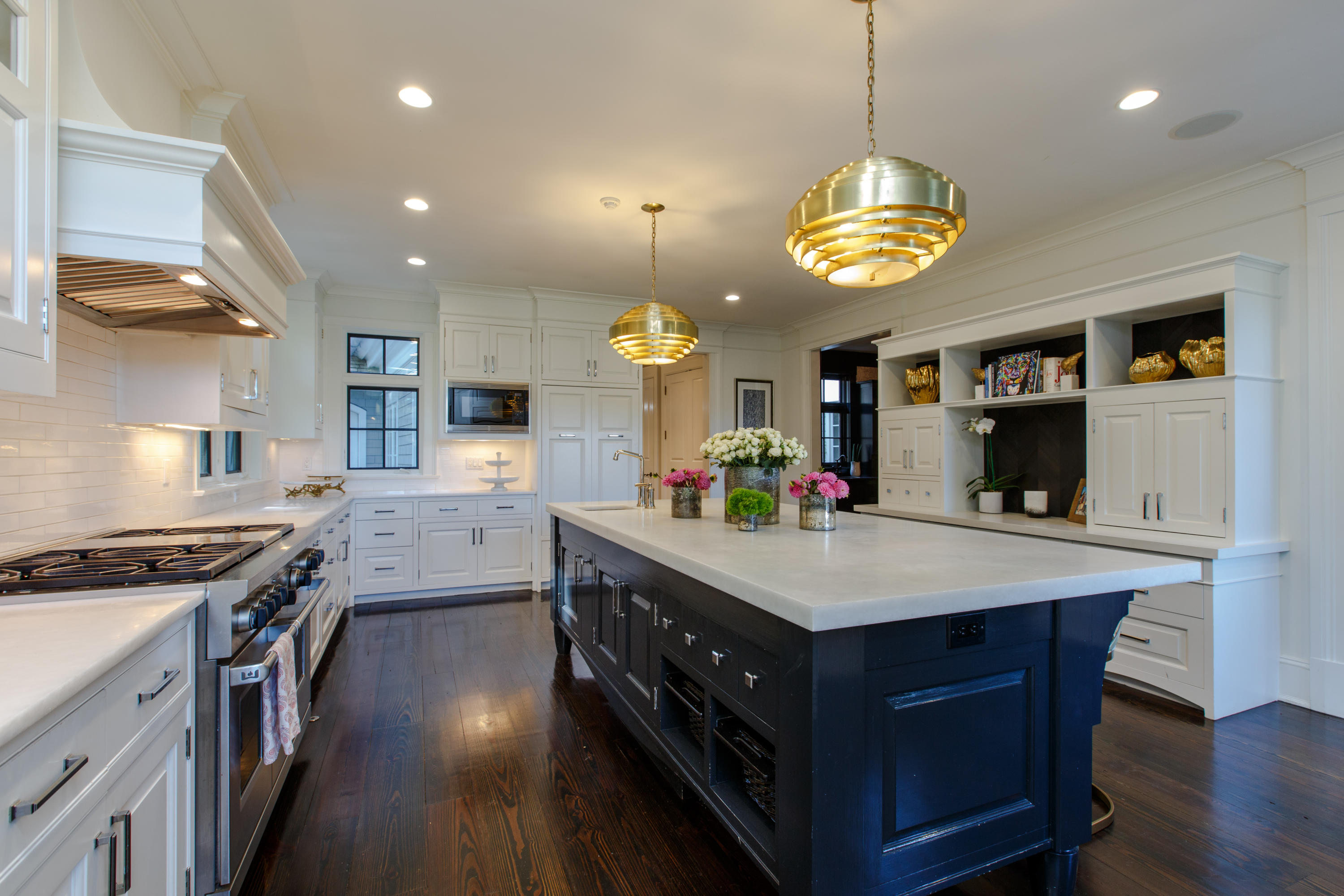 51 Lambert Road New Canaan, CT 06840 - Photo 15 of 62 a kitchen with kitchen island a wooden floor and a view of living room