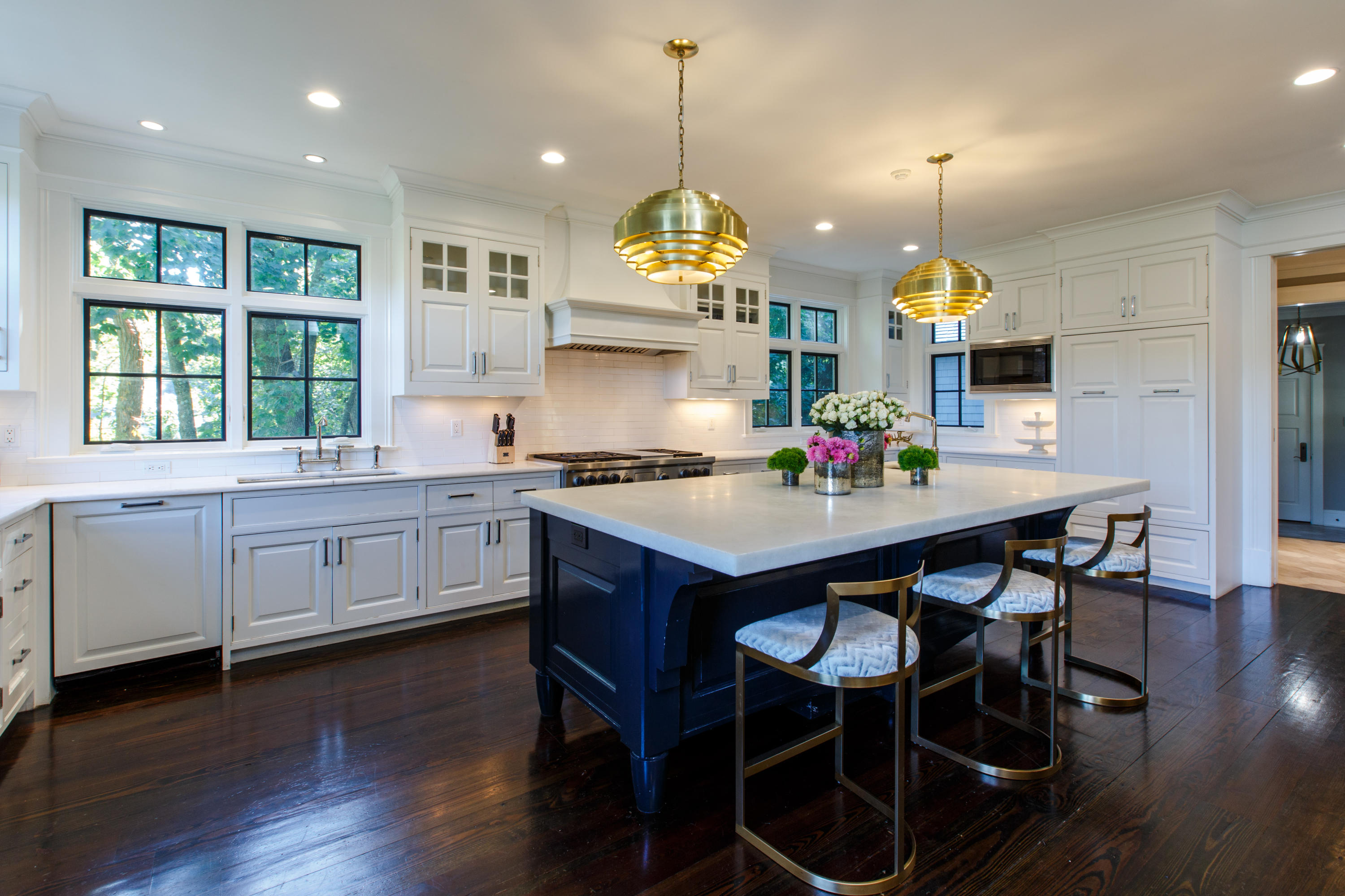 51 Lambert Road New Canaan, CT 06840 - Photo 19 of 62 a kitchen with granite countertop a table chairs stove and white cabinets