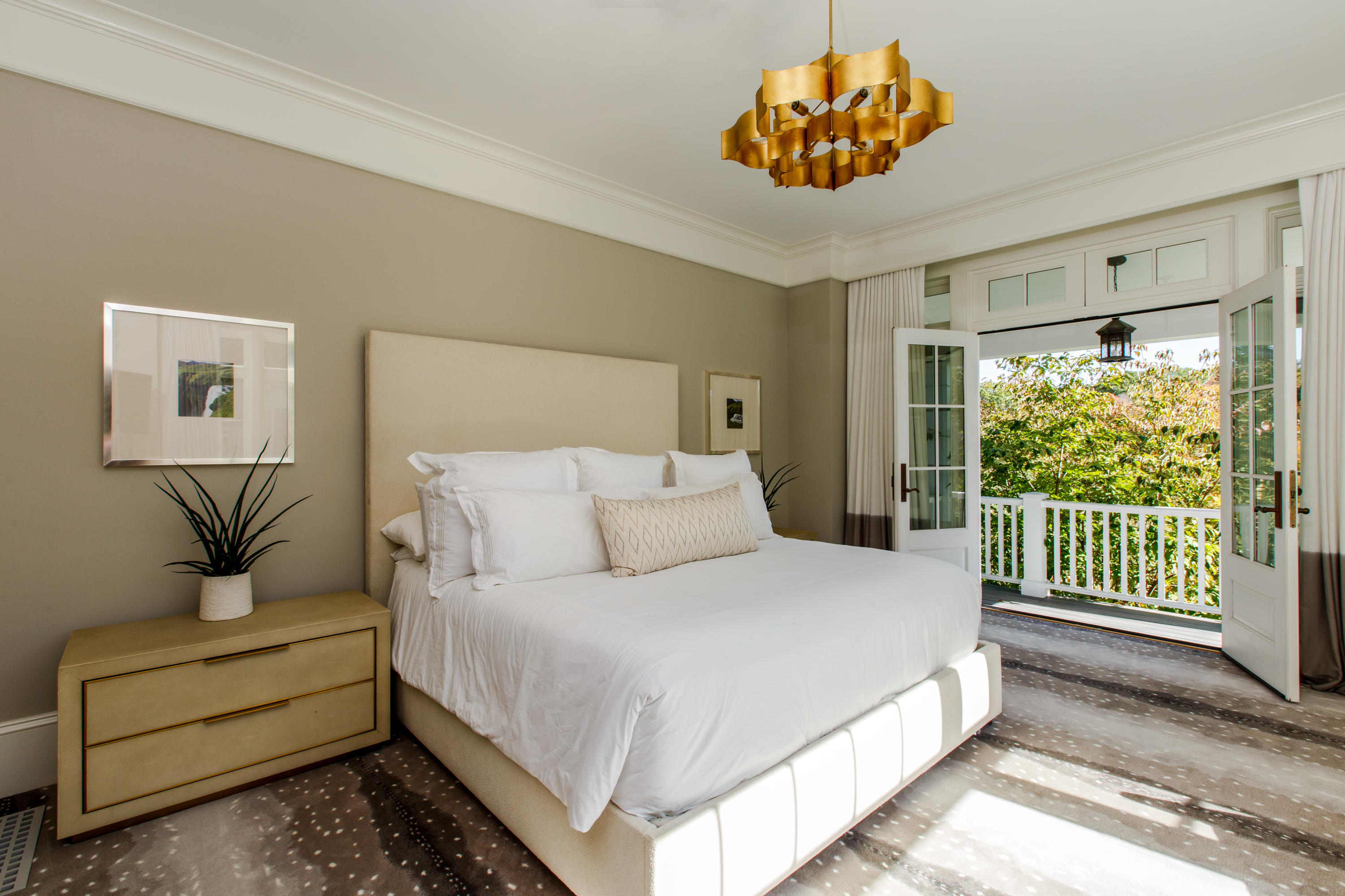 51 Lambert Road New Canaan, CT 06840 - Photo 26 of 62 a bedroom with a large bed and a chandelier