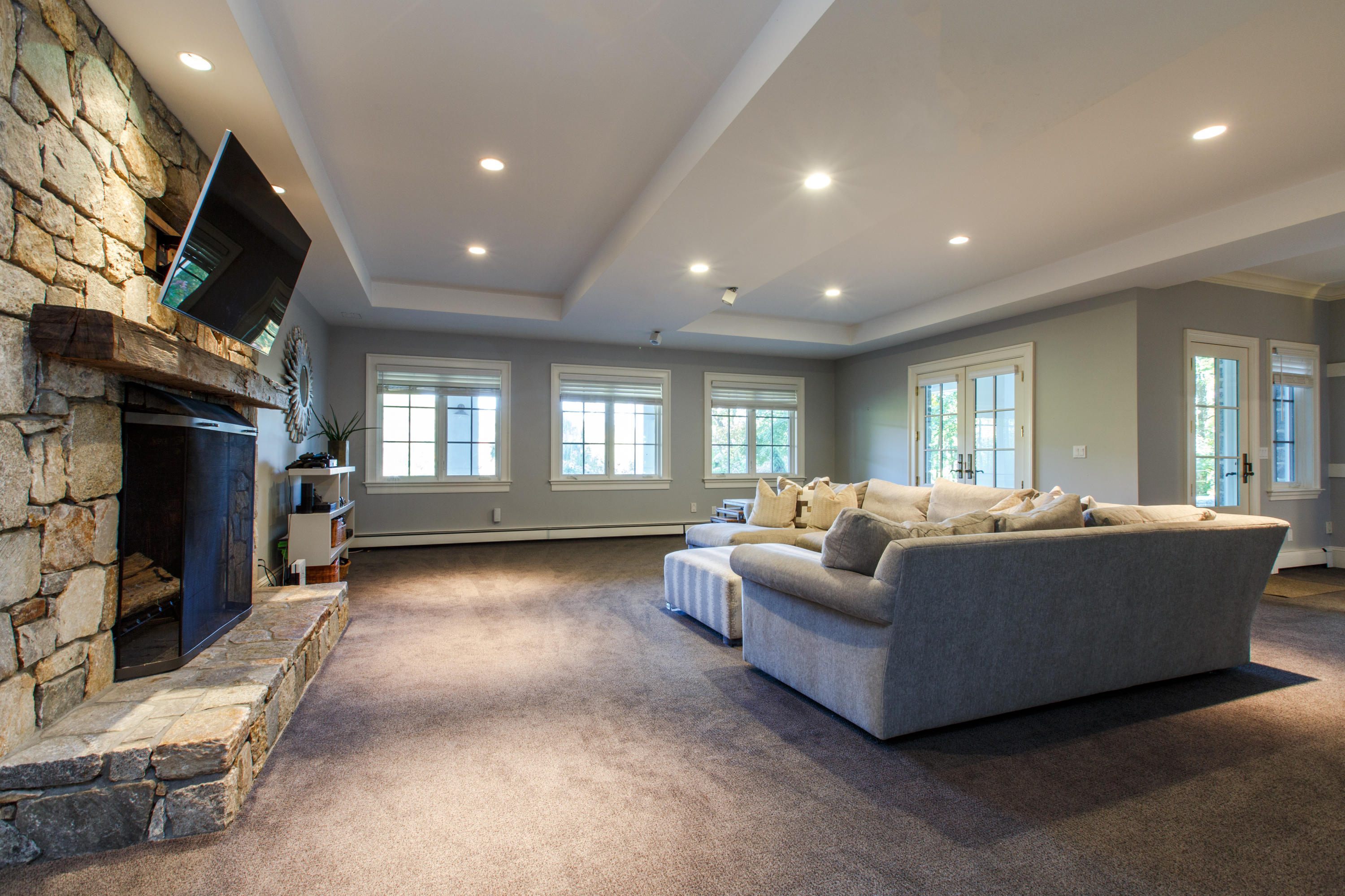 51 Lambert Road New Canaan, CT 06840 - Photo 48 of 62 a living room with furniture a flat screen tv and a fireplace