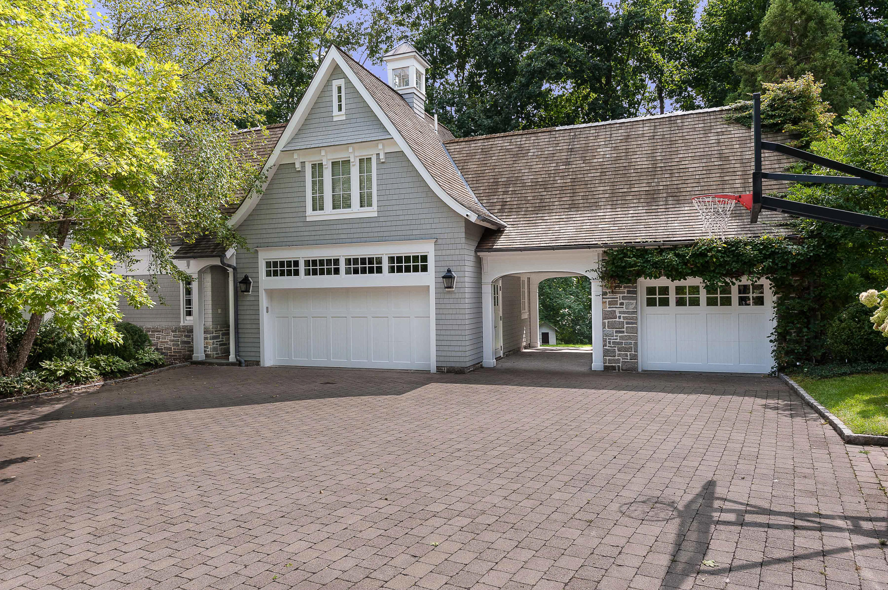 51 Lambert Road New Canaan, CT 06840 - Photo 51 of 62 a front view of a house with a yard and garage
