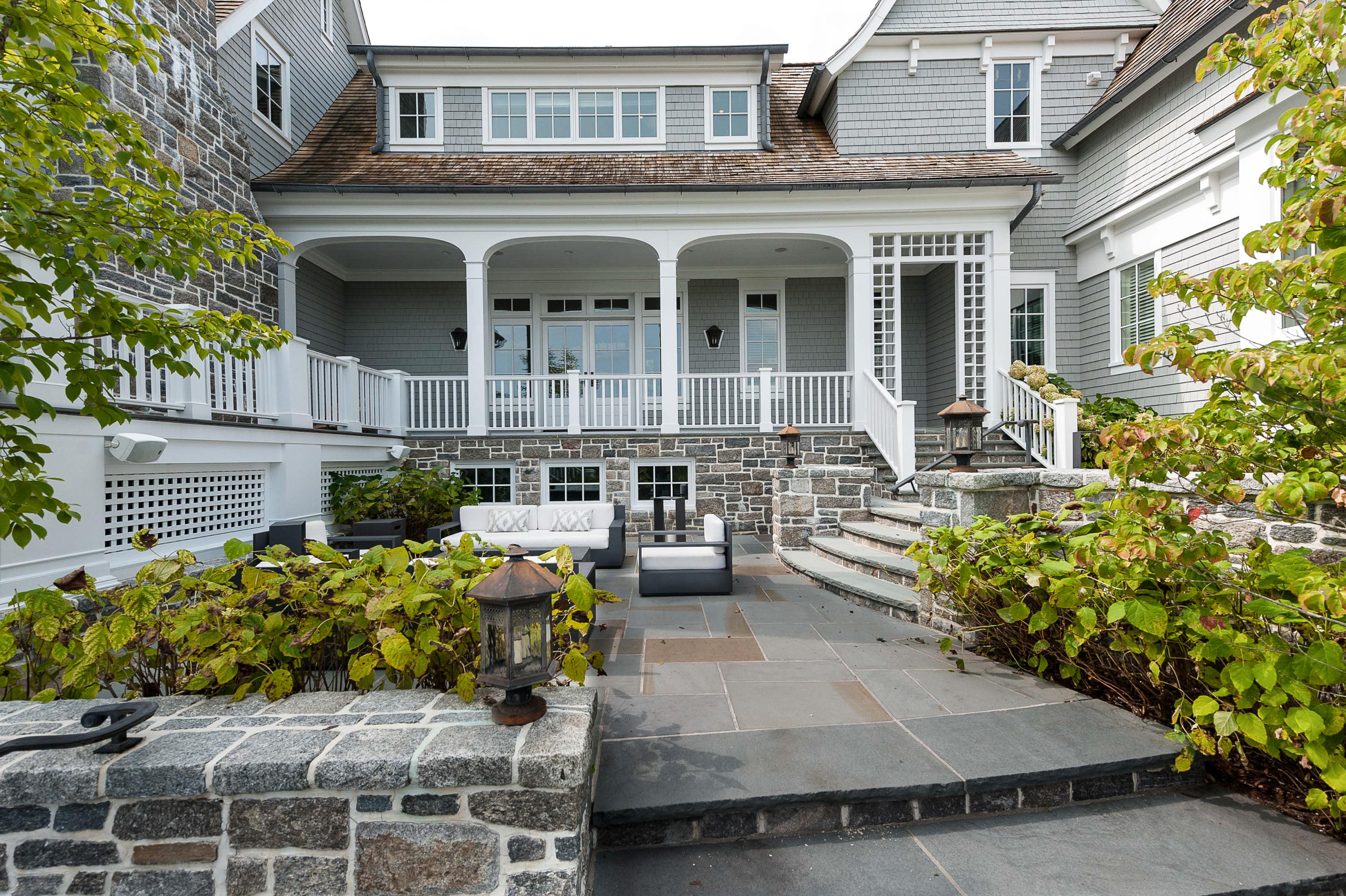 51 Lambert Road New Canaan, CT 06840 - Photo 54 of 62 a front view of a house with outdoor seating