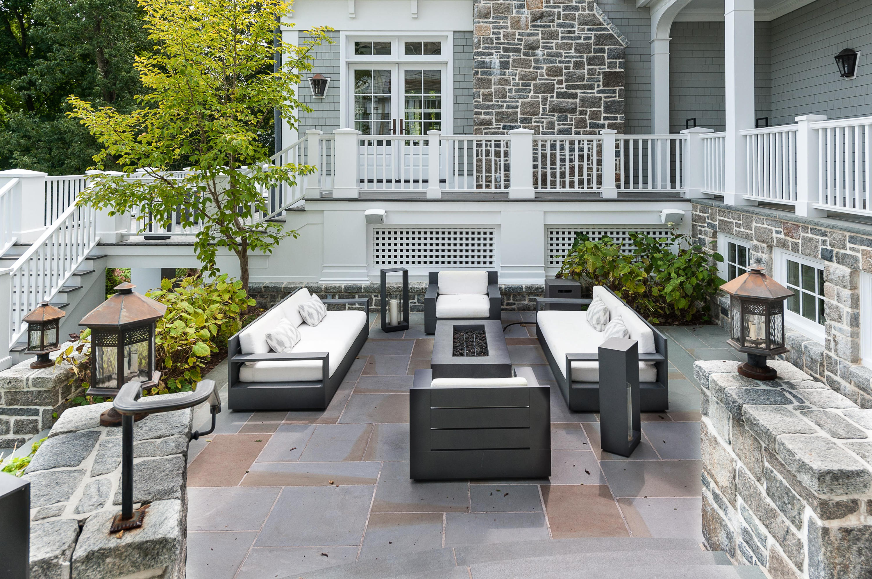 51 Lambert Road New Canaan, CT 06840 - Photo 55 of 62 a view of a patio with couches table and chairs and potted plants