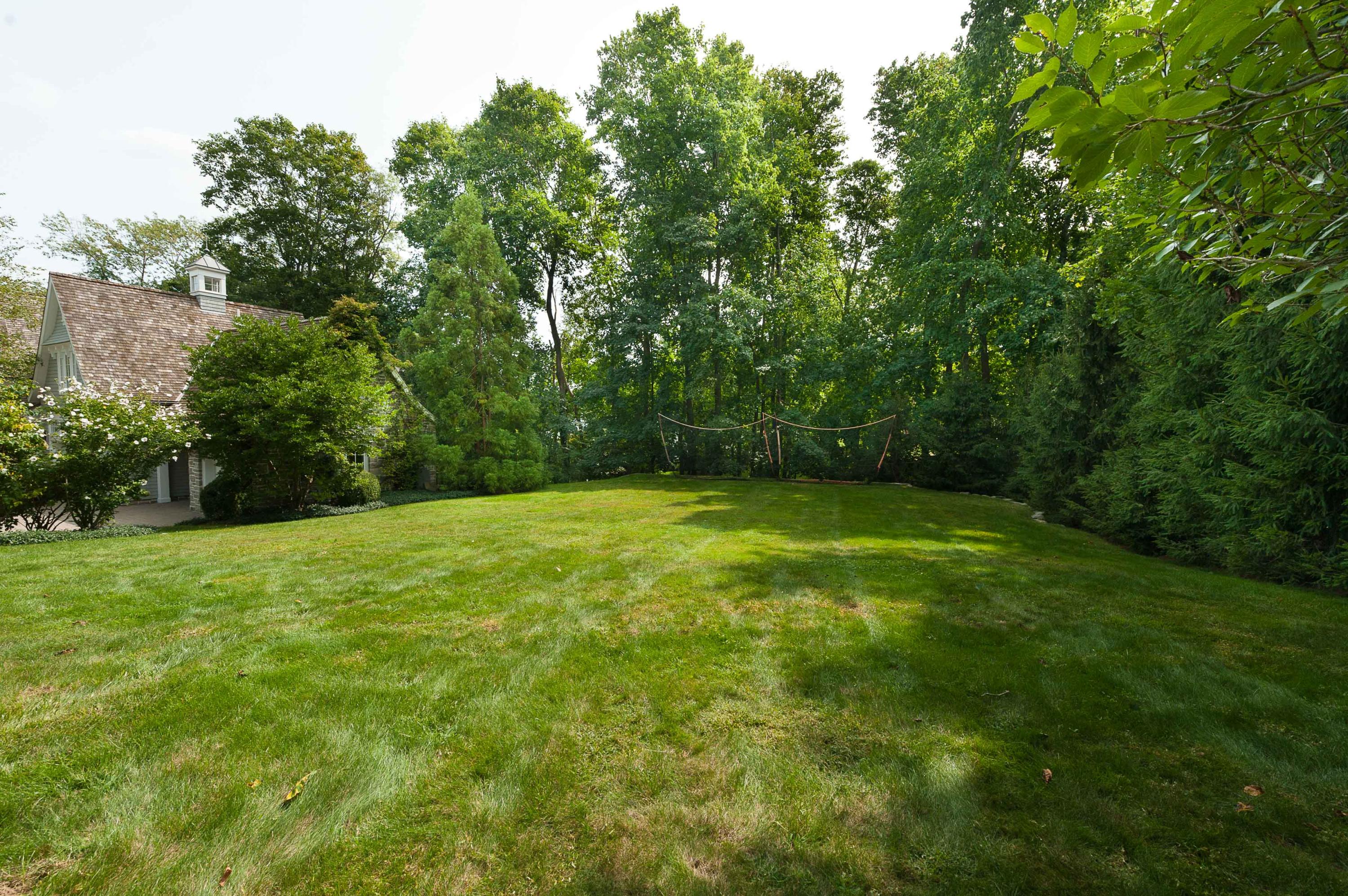 51 Lambert Road New Canaan, CT 06840 - Photo 56 of 62 a view of a yard with a house