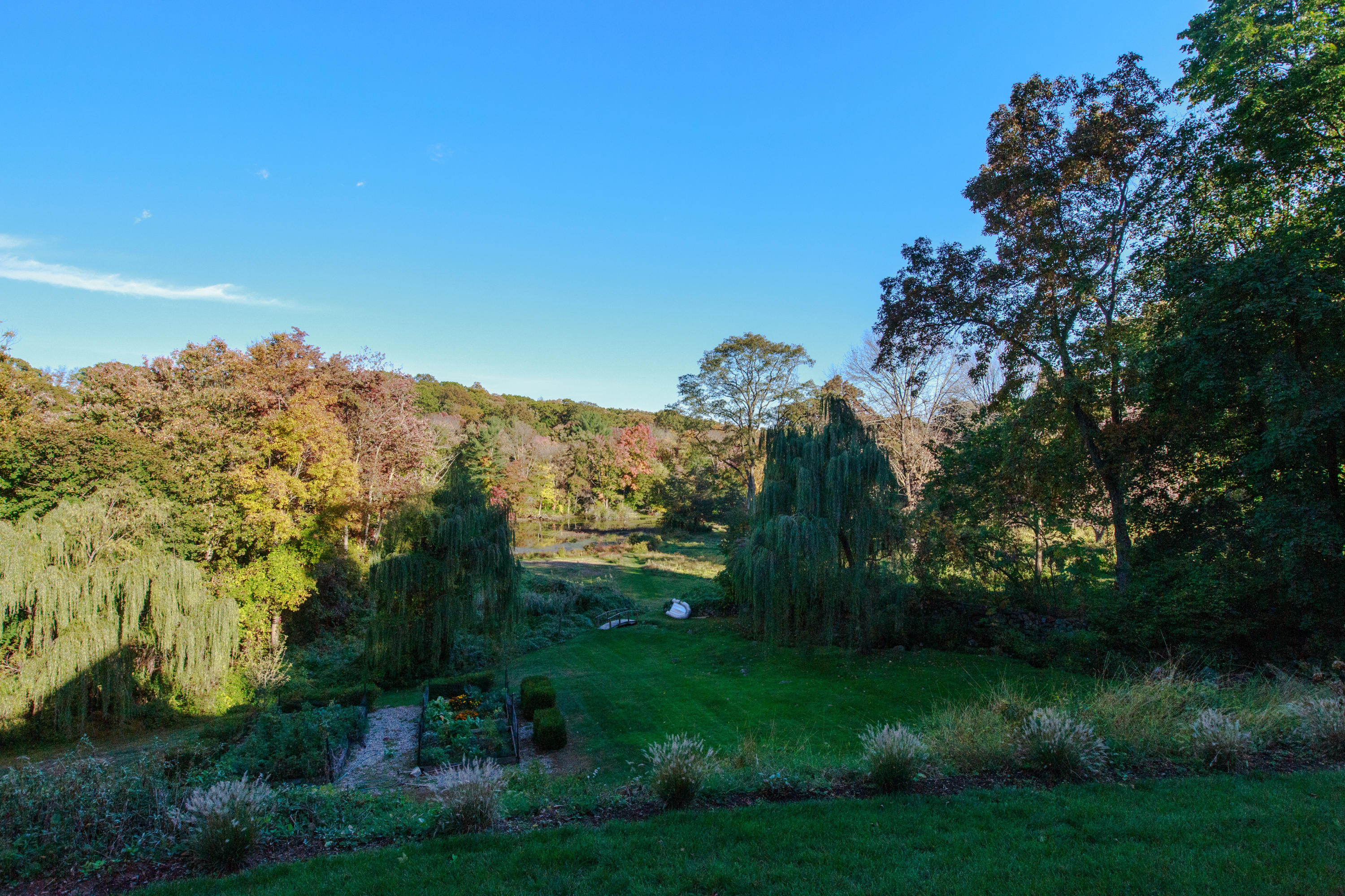 51 Lambert Road New Canaan, CT 06840 - Photo 58 of 62 a view of a lake with a garden