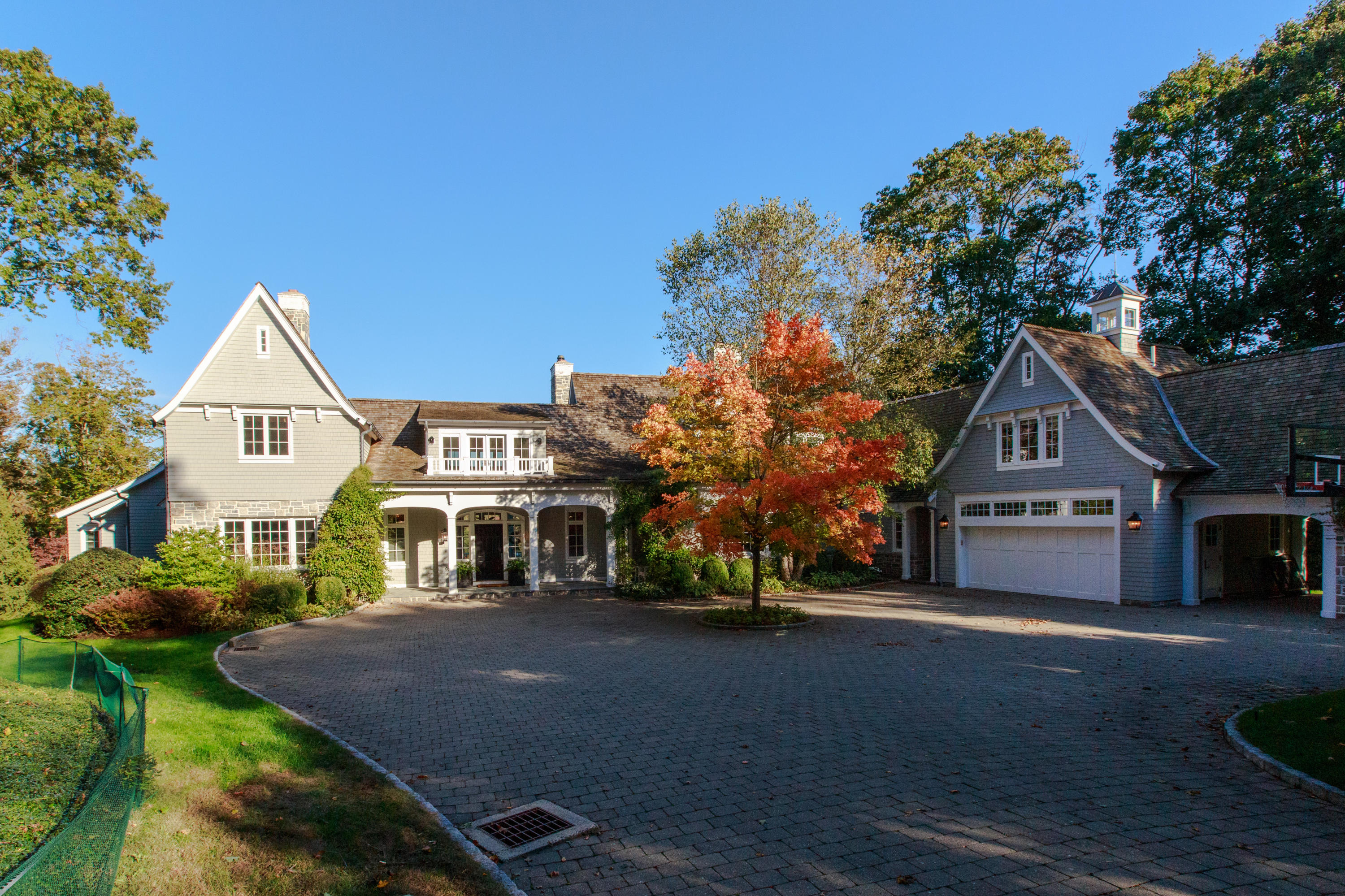 51 Lambert Road New Canaan, CT 06840 - Photo 59 of 62 a front view of a house with a yard