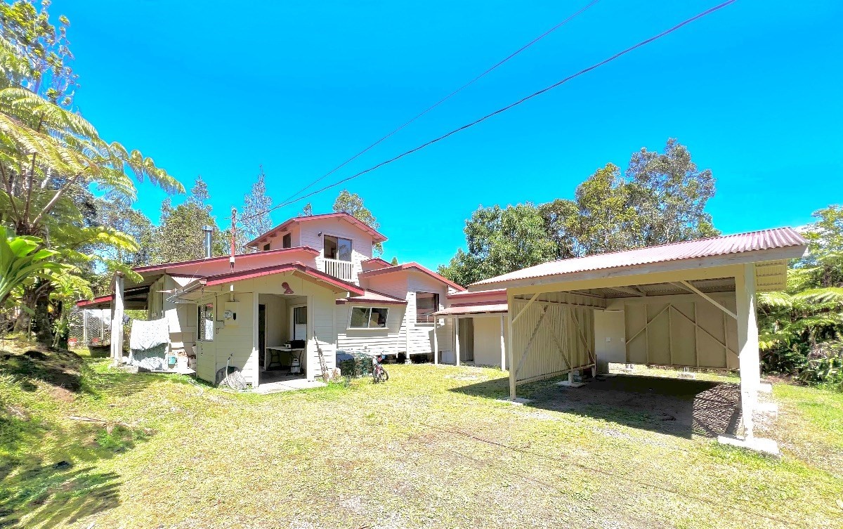 11-3276 Lehuapele Road, Unit 3 Hilo, HI 96720 - Photo 1 of 1 a front view of a house with a yard and garage