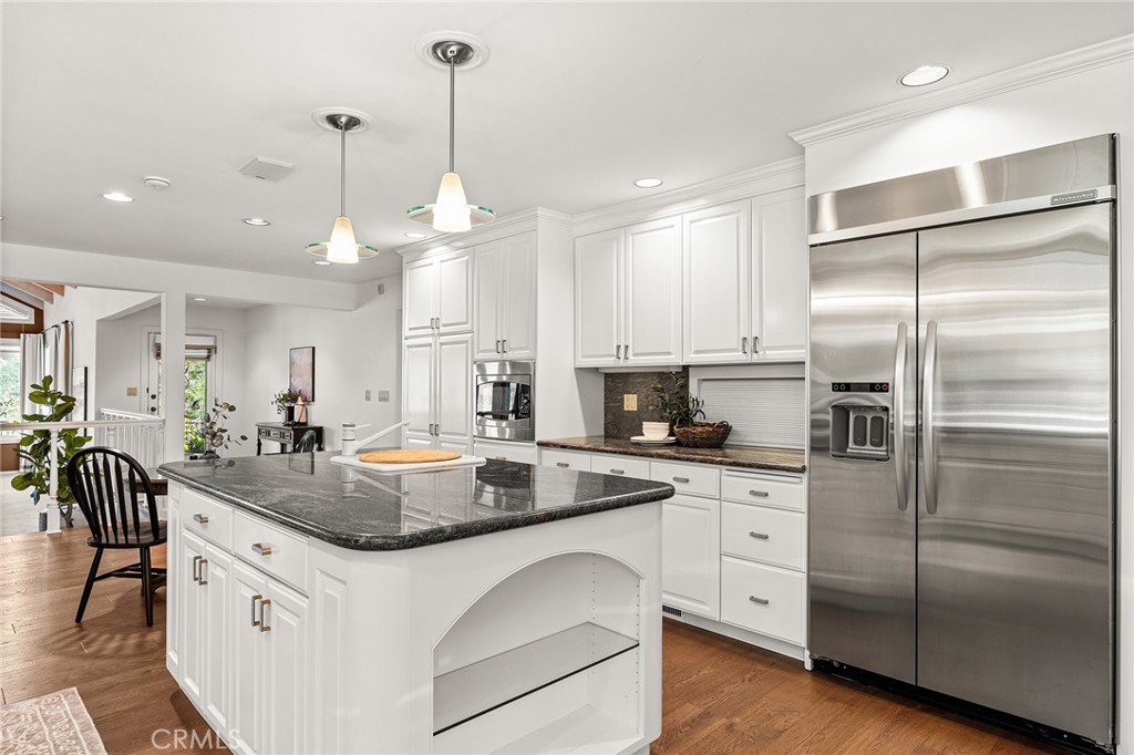 14868 Eagle Ridge Drive Forest Ranch, CA 95942 - Photo 18 of 69 a kitchen with stainless steel appliances granite countertop a refrigerator a sink dishwasher a stove and white cabinets with wooden floor
