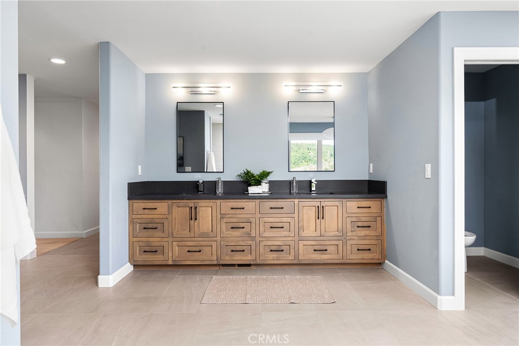 14868 Eagle Ridge Drive Forest Ranch, CA 95942 - Photo 34 of 69 a bathroom with a double vanity sink and mirror