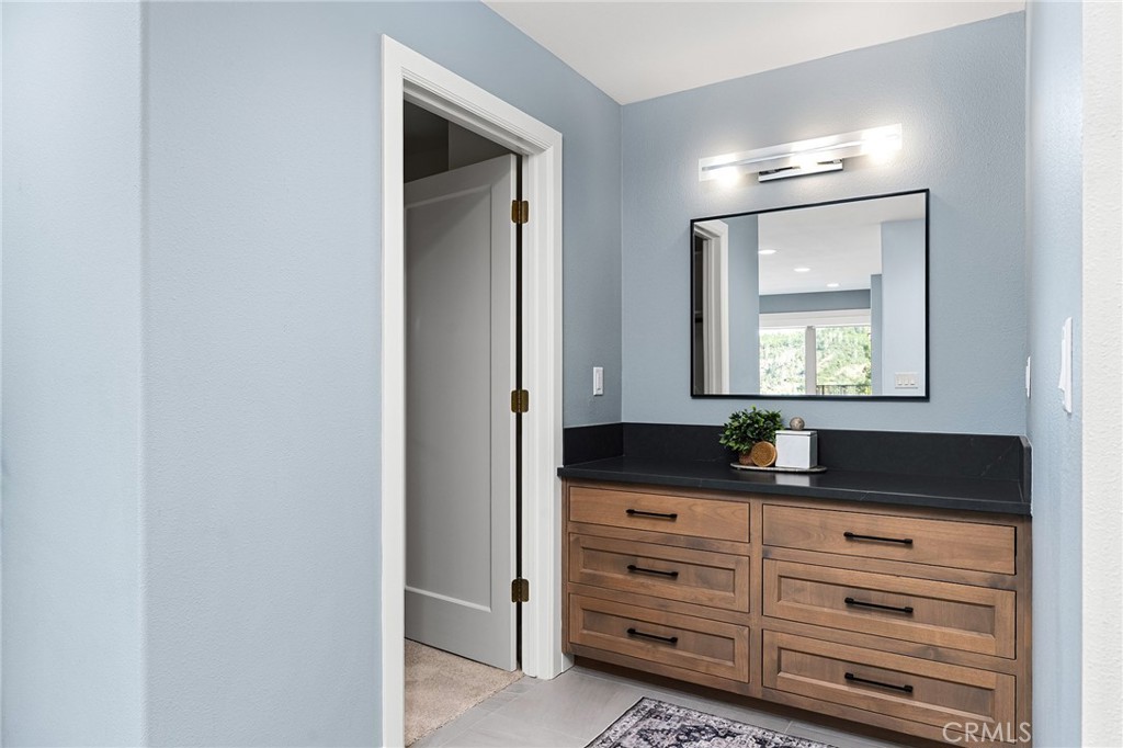 14868 Eagle Ridge Drive Forest Ranch, CA 95942 - Photo 35 of 69 a bathroom with a granite countertop sink and a mirror