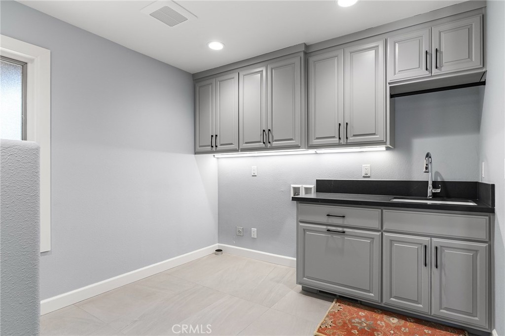 14868 Eagle Ridge Drive Forest Ranch, CA 95942 - Photo 39 of 69 a kitchen with granite countertop white cabinets and sink