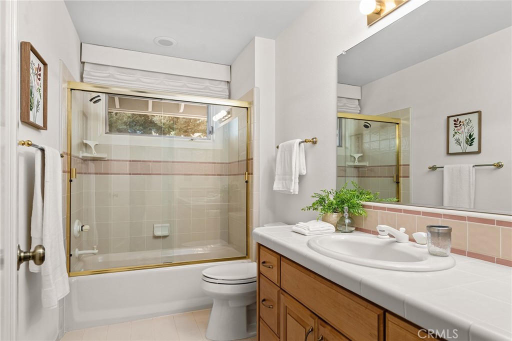 14868 Eagle Ridge Drive Forest Ranch, CA 95942 - Photo 43 of 69 a bathroom with a granite countertop sink toilet and shower