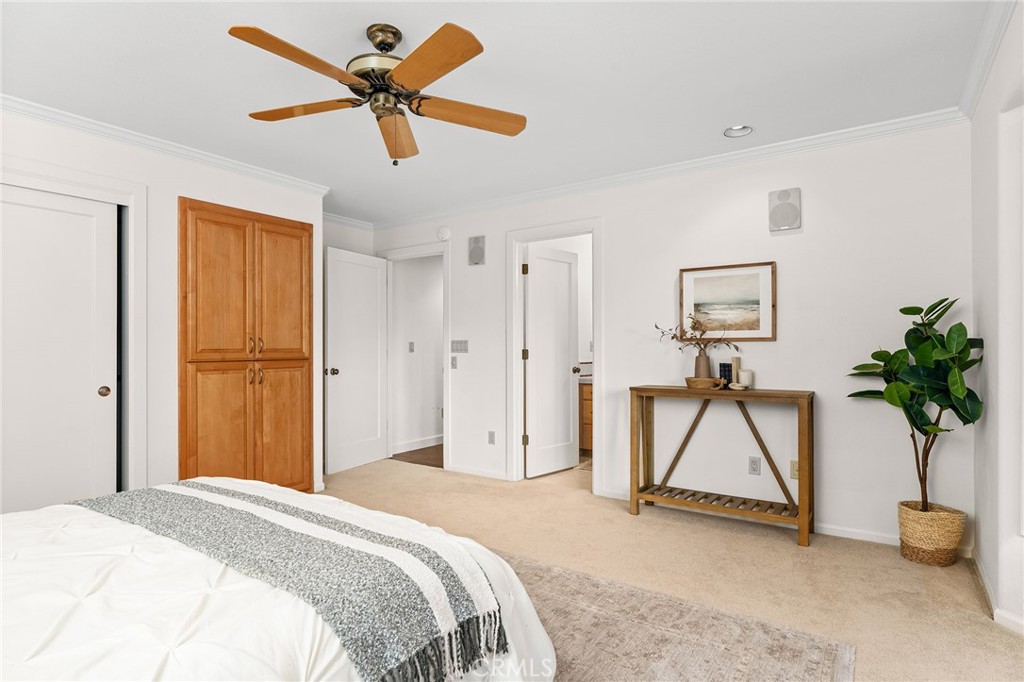 14868 Eagle Ridge Drive Forest Ranch, CA 95942 - Photo 46 of 69 a bedroom with a bed and a chandelier