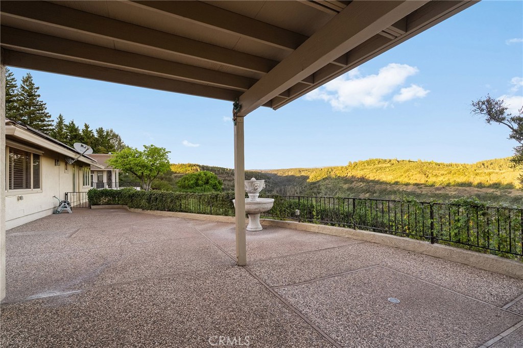 14868 Eagle Ridge Drive Forest Ranch, CA 95942 - Photo 51 of 69 a view of a backyard with couches under an umbrella