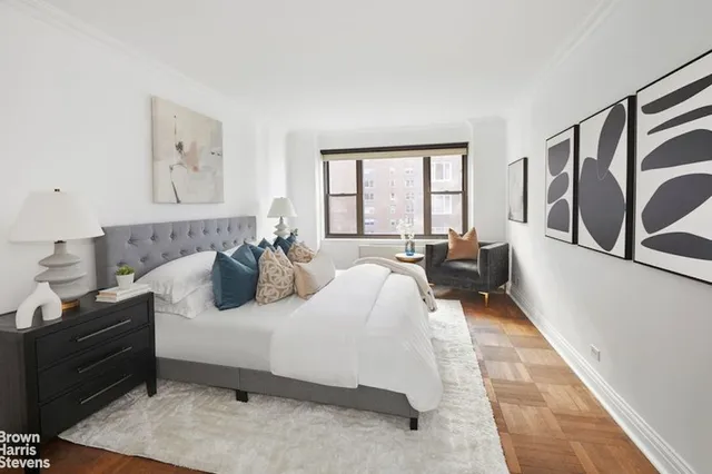 a bedroom with furniture and a large window