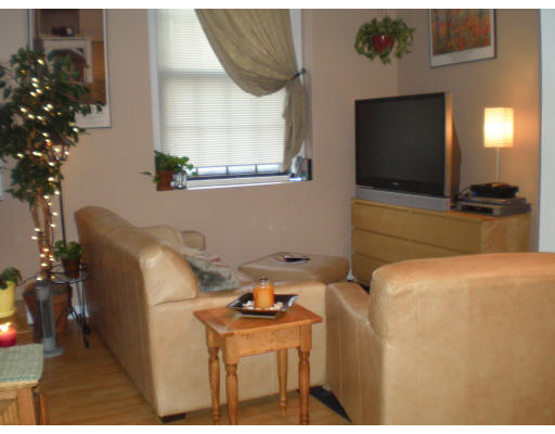 21 Linden Street, Unit 203 Quincy, MA 02170 - Photo 3 of 8 a kitchen with a refrigerator and a microwave