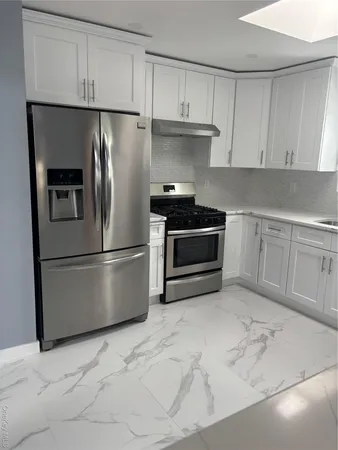 a kitchen with stainless steel appliances granite countertop a refrigerator sink and cabinets