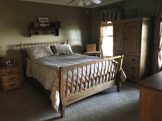 2115 East 875th Road Tonica, IL 61370 - Photo 16 of 41 a bed sitting in a bedroom next to a window